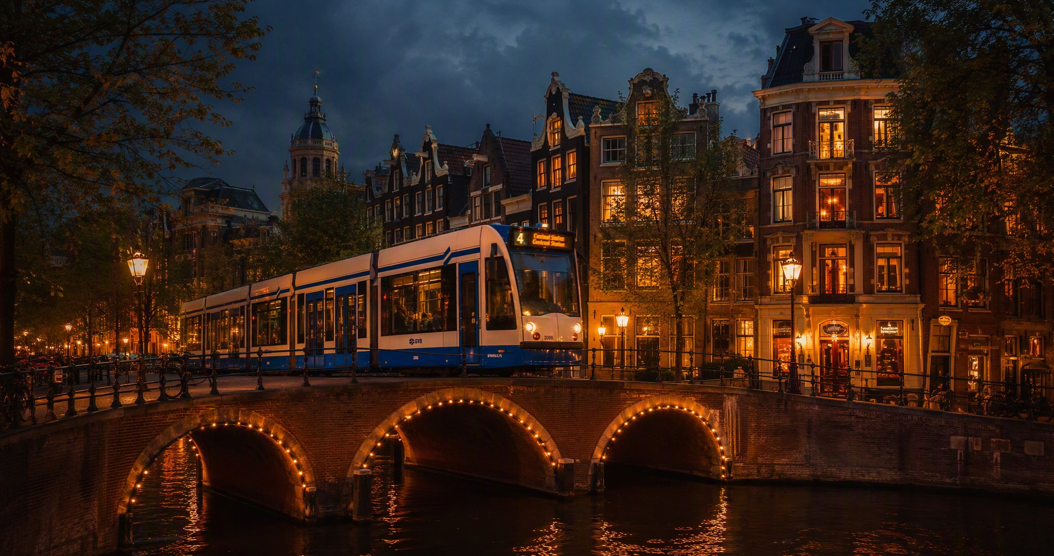 Tram 4 crossing a canal bridge at dusk